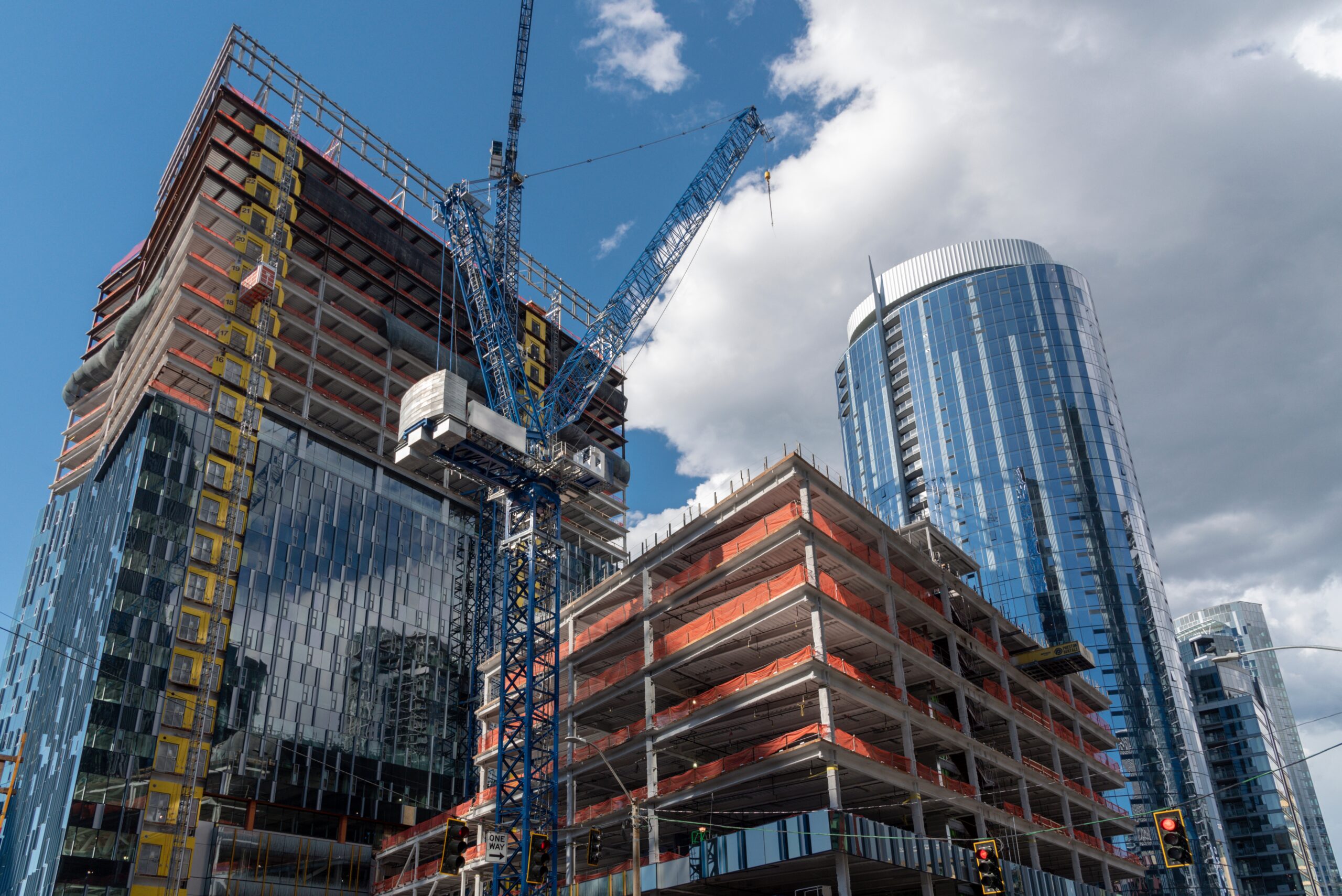 Construction cranes and new buildings in an urban area